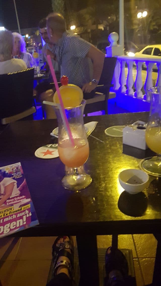 Glowing drinks lined up at the bar